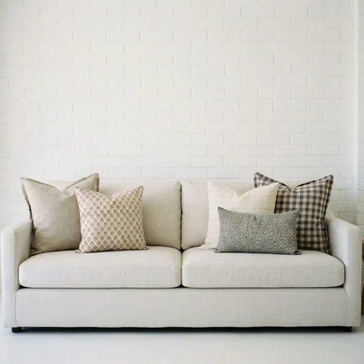 Darcy cushions displayed on sofa with soft beige, grey and check patterned cushions.
