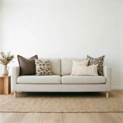 Mabel cushions styled on sofa with brown, cream and floral patterned cushions.
