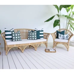 White outdoor living area with a set of 7 green couch cushions from the Byron collection.