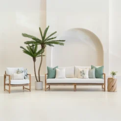 A set of 7 sagewood coloured outdoor sofa cushions siting on a white sofa.