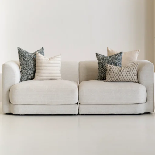 The Sable designer set of 5 sofa cushions is styled on a natural-coloured sofa.