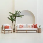 Tropica outdoor cushions in red and white patterns on sofa and chair.