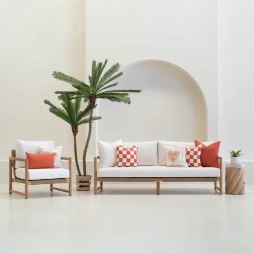 Tropica outdoor cushions in red and white patterns on sofa and chair.