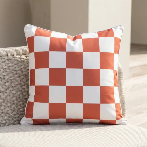 Tropica red check cushion with white squares on woven outdoor chair.
