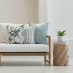 Wildgrove frond cushions with blue stripes and botanical prints on sofa.